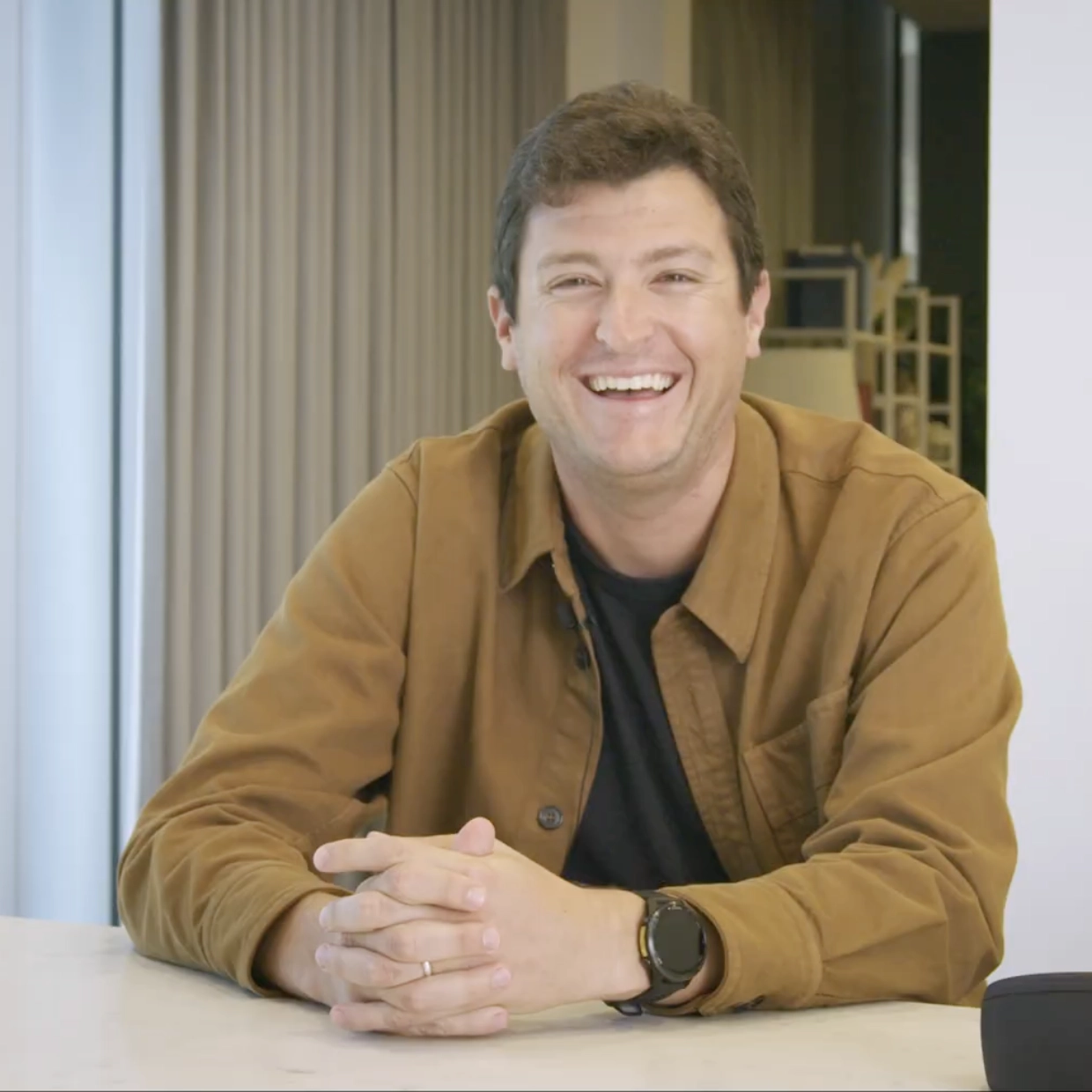 A man sitting and speaking, representing ‘Do your most challenging work.’